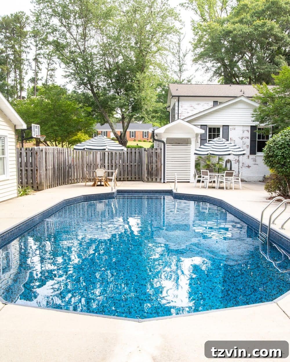 Newly renovated pool area with Obsidian liner, limewashed brick, and glimpse of the patio