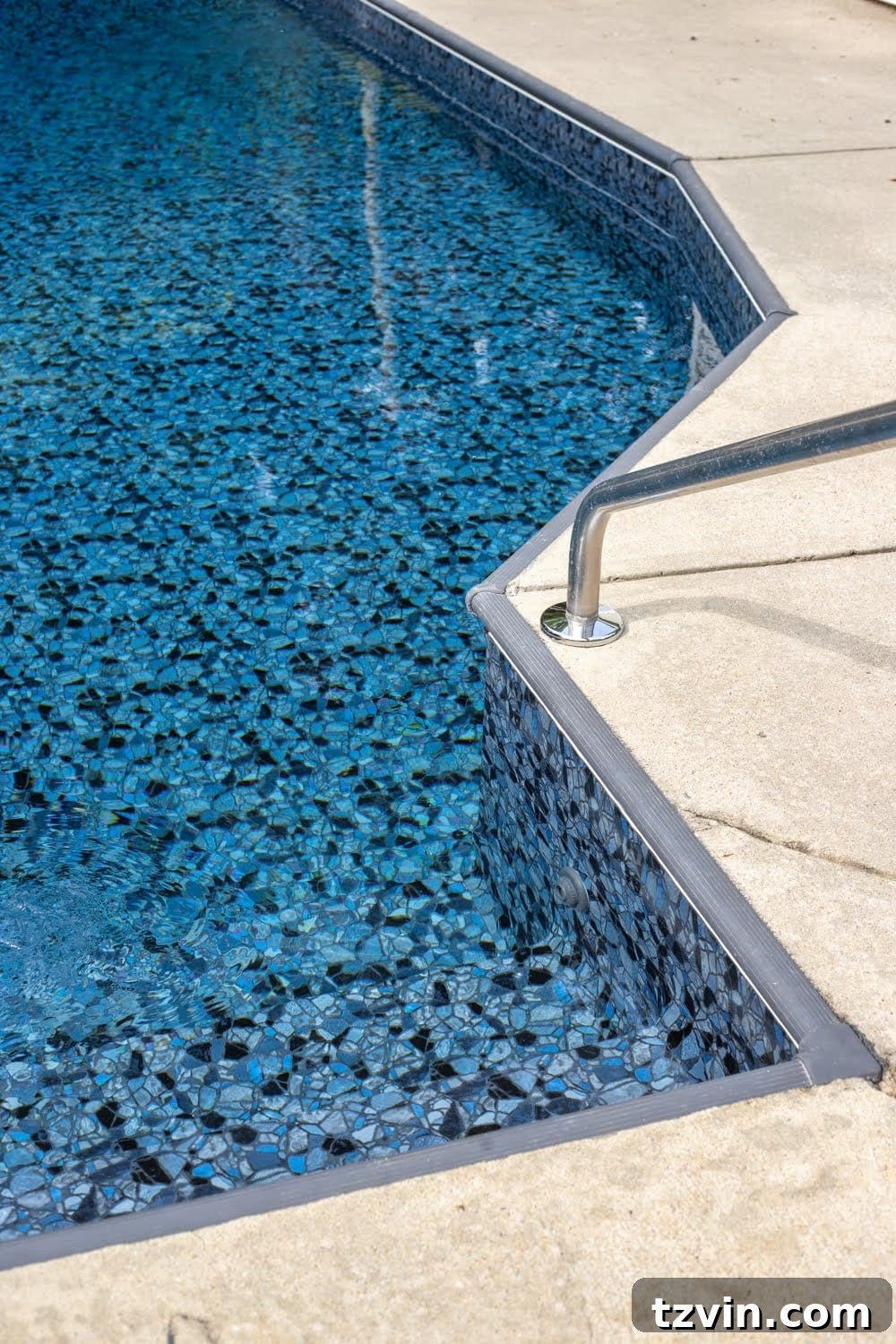 Newly installed pool liner, Obsidian TrueStone Collection from GLI Pool Products, with charcoal gray painted coping strip