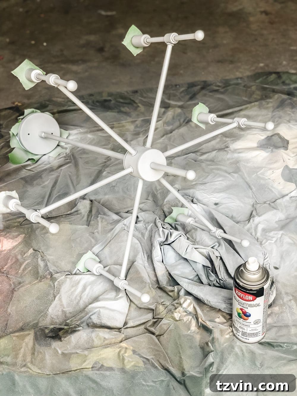 Chandelier Makeover: Our Favorite Brass Spray Paint 7 Taping off electrical components of a chandelier for spray painting