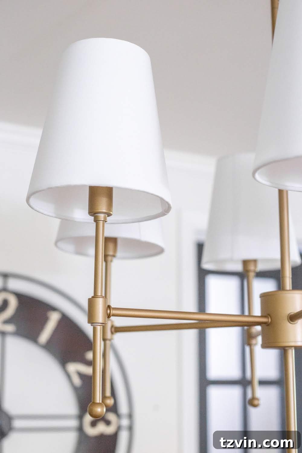 Chandelier Makeover: Our Favorite Brass Spray Paint 9 Applying Rust-Oleum Modern Farmhouse Metallic Gold spray paint to chandelier