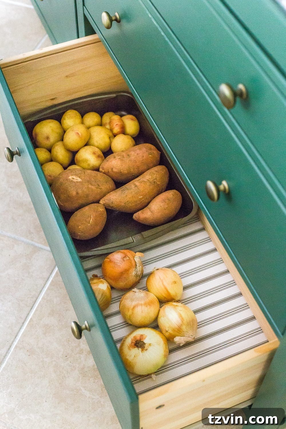 Ultimate IKEA Hemnes Pantry Cabinet Organization 11 Repurposed baking pan serving as a simple and effective potato and onion bin inside the IKEA Hemnes pantry, highlighting practical storage solutions.