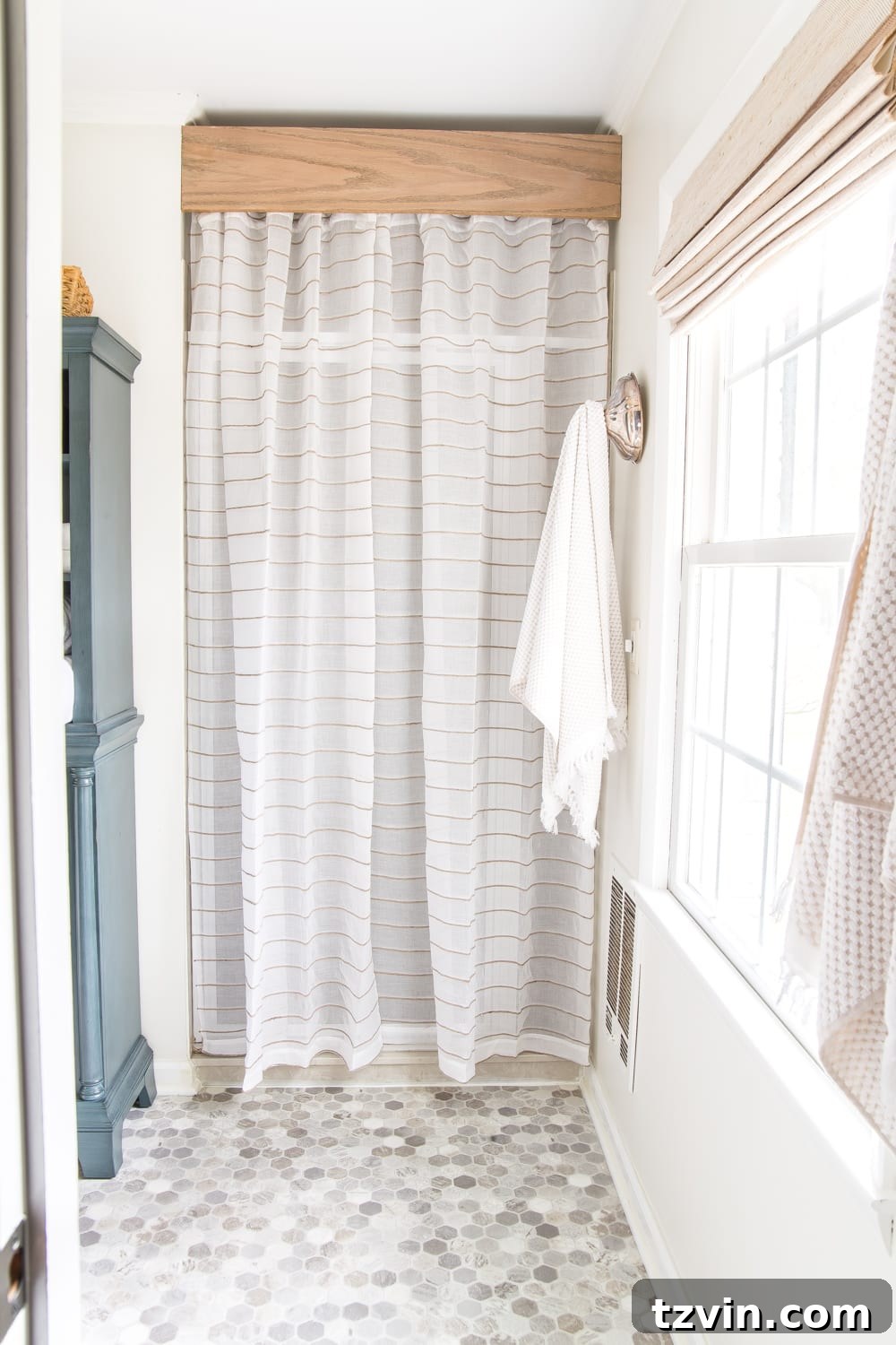 Big impact bathroom refresh with a stylish shower curtain covering an old shower door