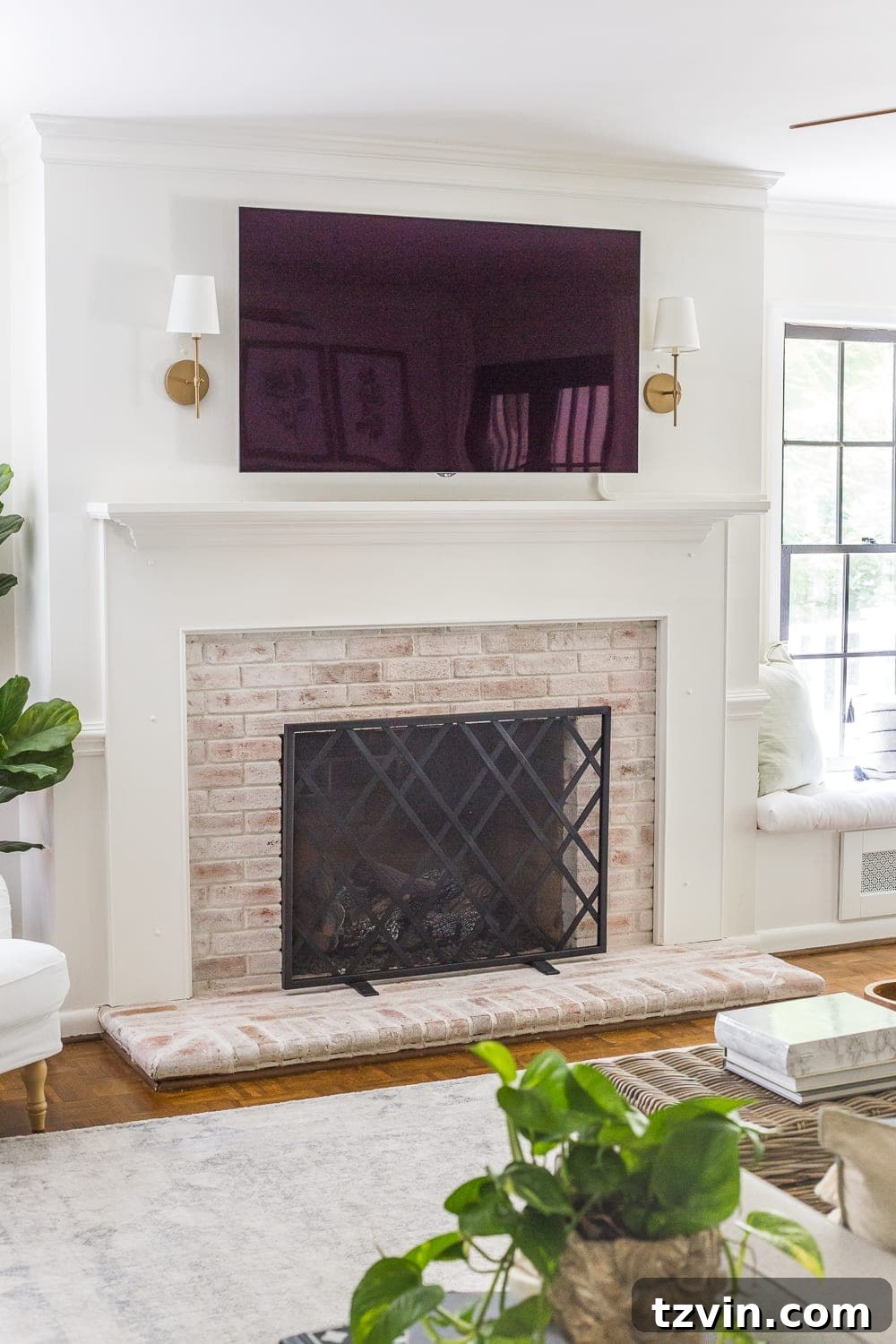 Beyond the Screen 12 Ways to Style Your TV Space 3 Minimalist mantel decor with sconces flanking a television