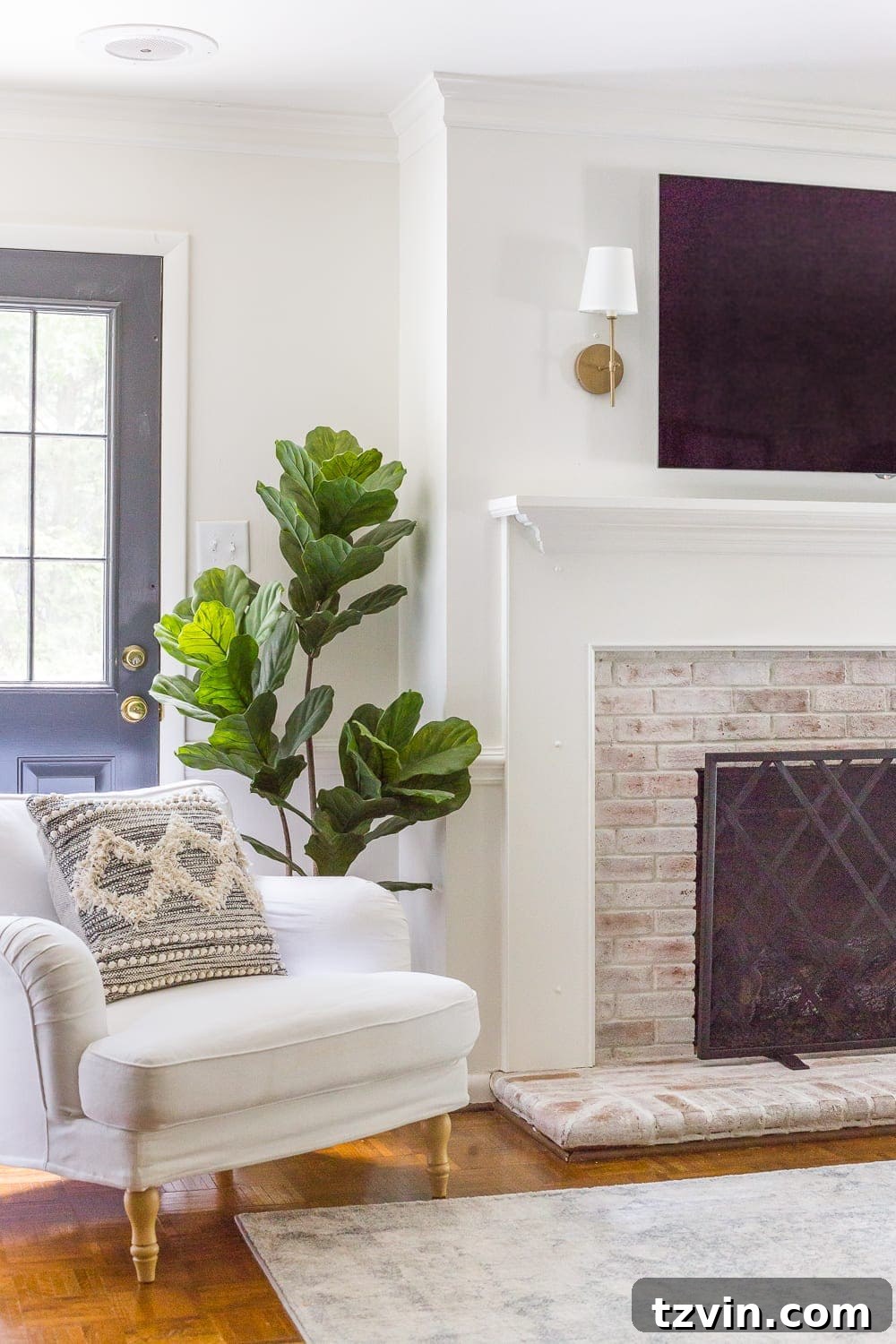 Beyond the Screen 12 Ways to Style Your TV Space 5 Minimalist mantel decor featuring sconces flanking a mounted TV