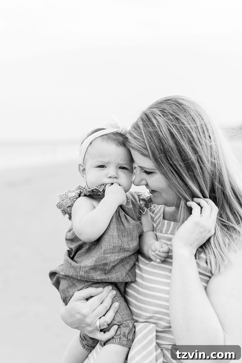 Mother embracing her baby gently, a moment of quiet connection amidst the challenges.
