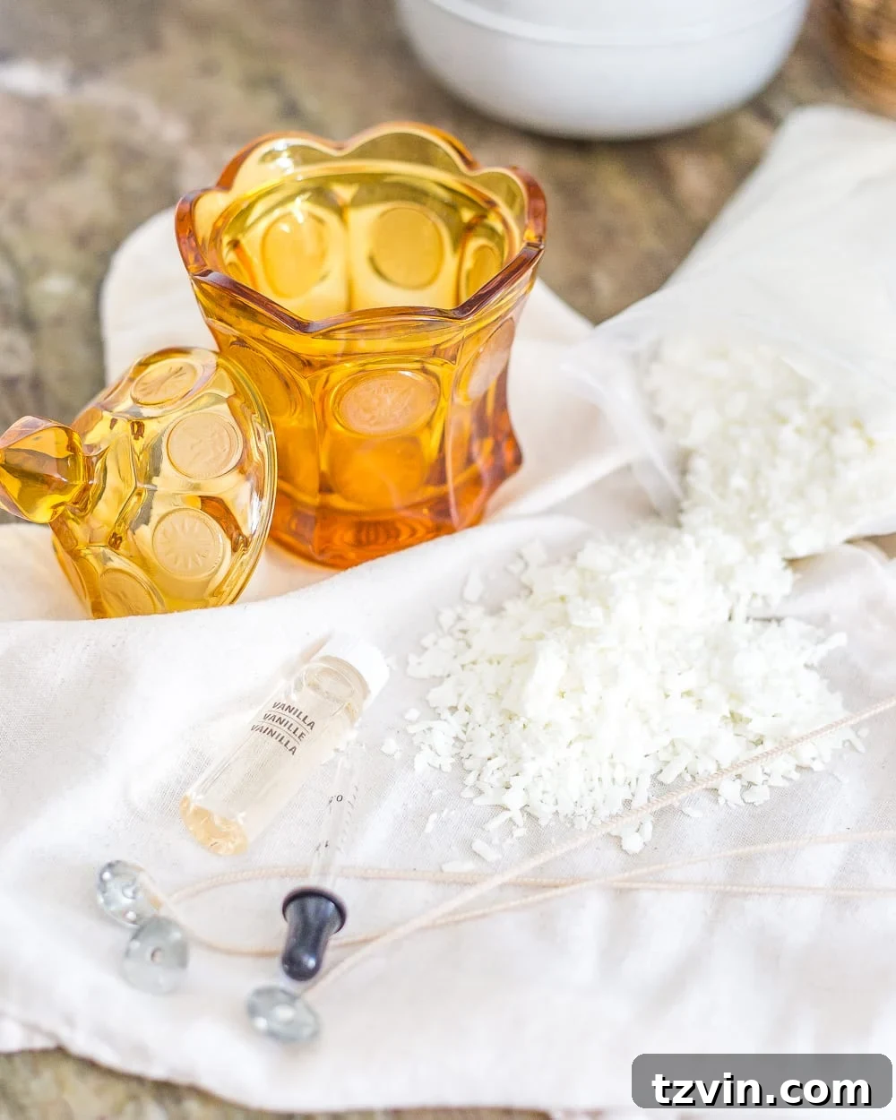 Finished DIY soy wax candles in repurposed amber glass dishes, glowing softly as home decor