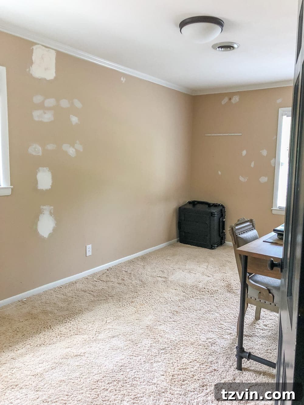 Our Guest Retreat Transformation Unveiled 4 Before image of the guest bedroom, highlighting the old carpet and sparse decor before its vintage chic transformation.