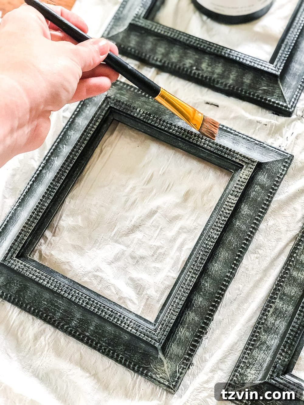 Upcycling Old Frames Into Stunning Antique Mirrors 7 Detail of dry brushed antique gold and sage paint on frame