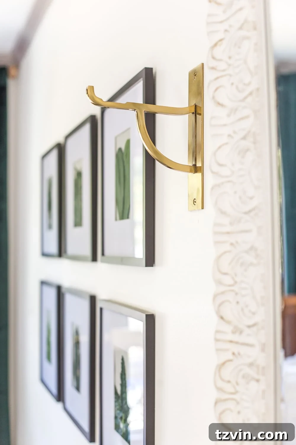A close-up of a decorative wall hook in a guest bedroom, useful for hanging towels, robes, or bags.
