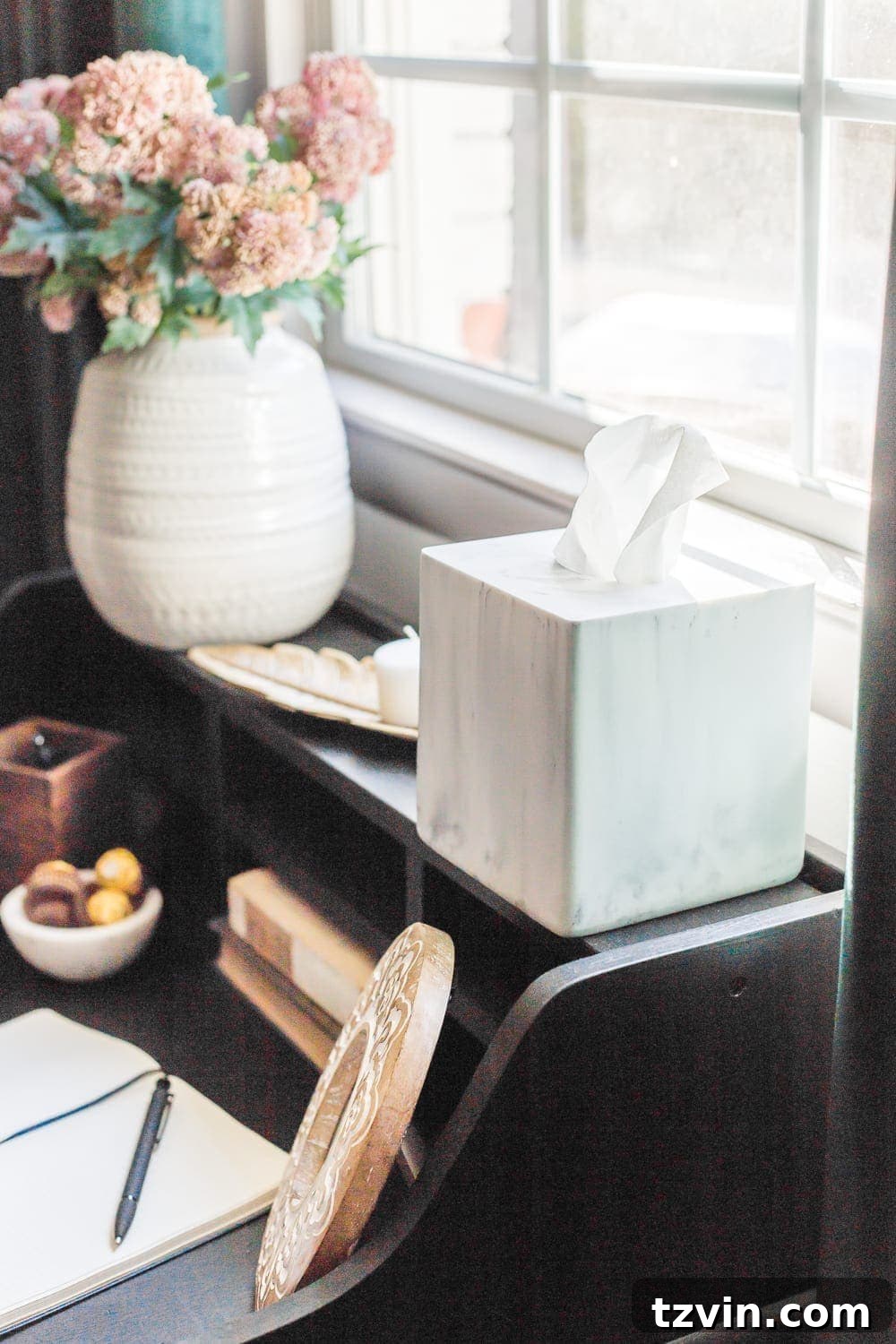 A marble-covered tissue box on a bedside table, emphasizing basic yet thoughtful guest room amenities.