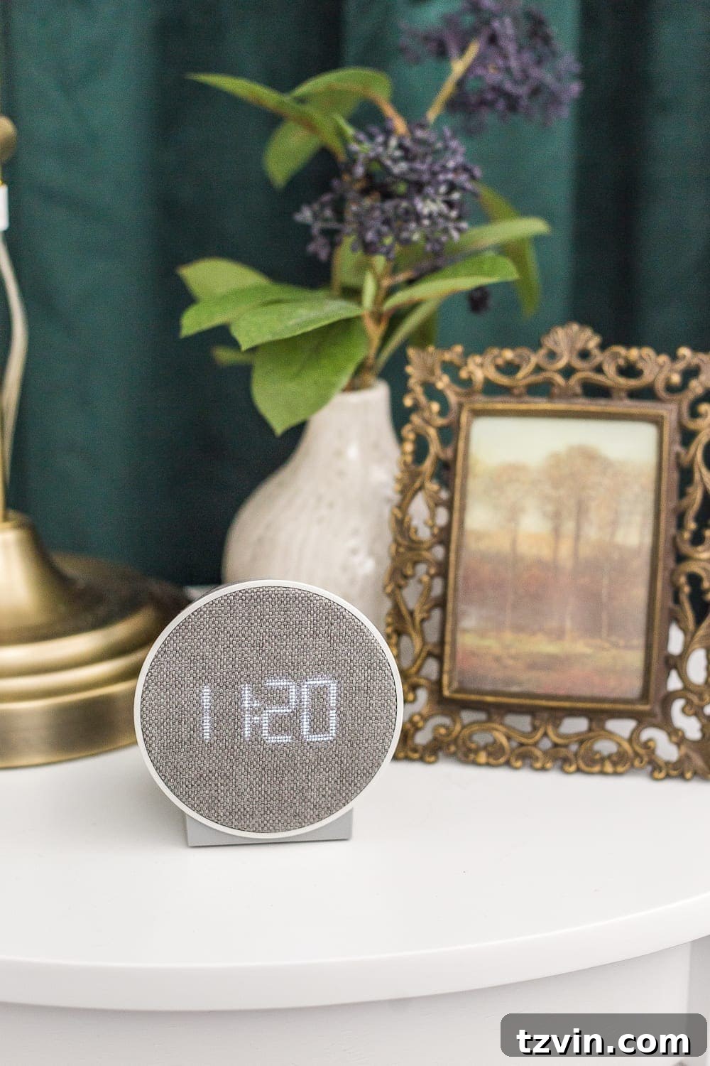 A bedside table with an alarm clock, highlighting essential guest room amenities for comfort and convenience.