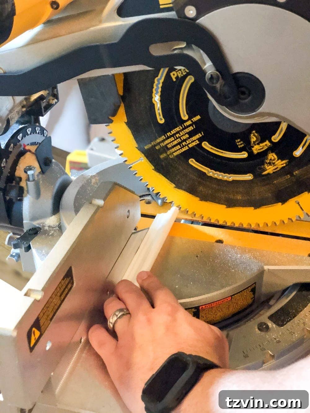 Cutting finger-joint panel cap molding with a miter saw for a grid wall