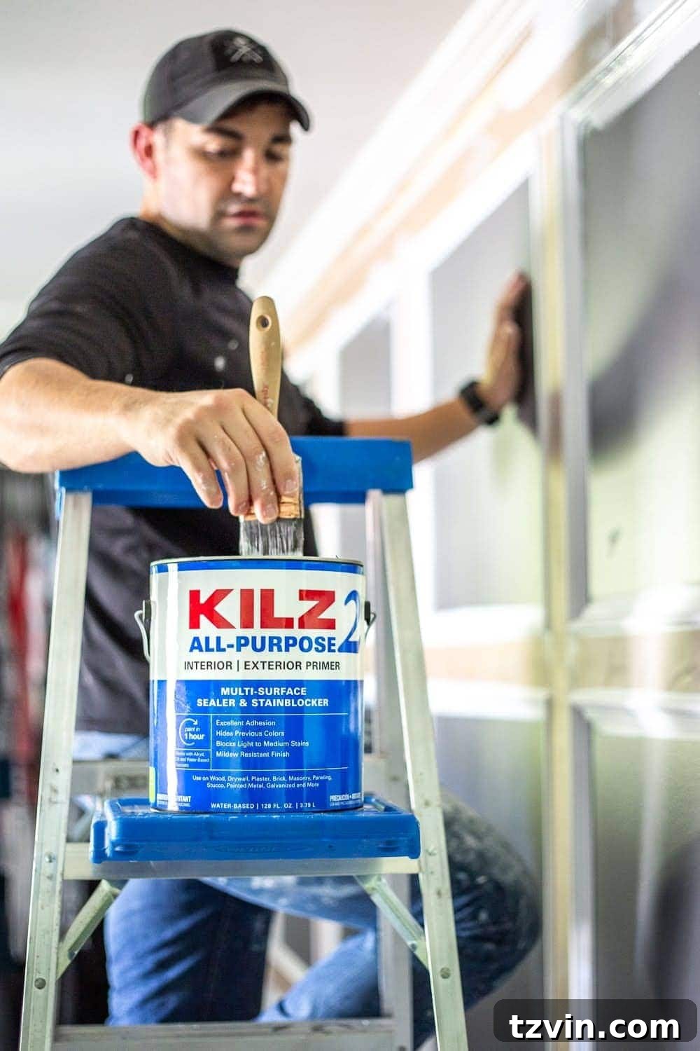 Master Bedroom Transformation: 5 Hard-Earned Painting Insights 4 Applying KILZ 2 All-Purpose primer to a wall, showcasing the importance of proper prep before painting.