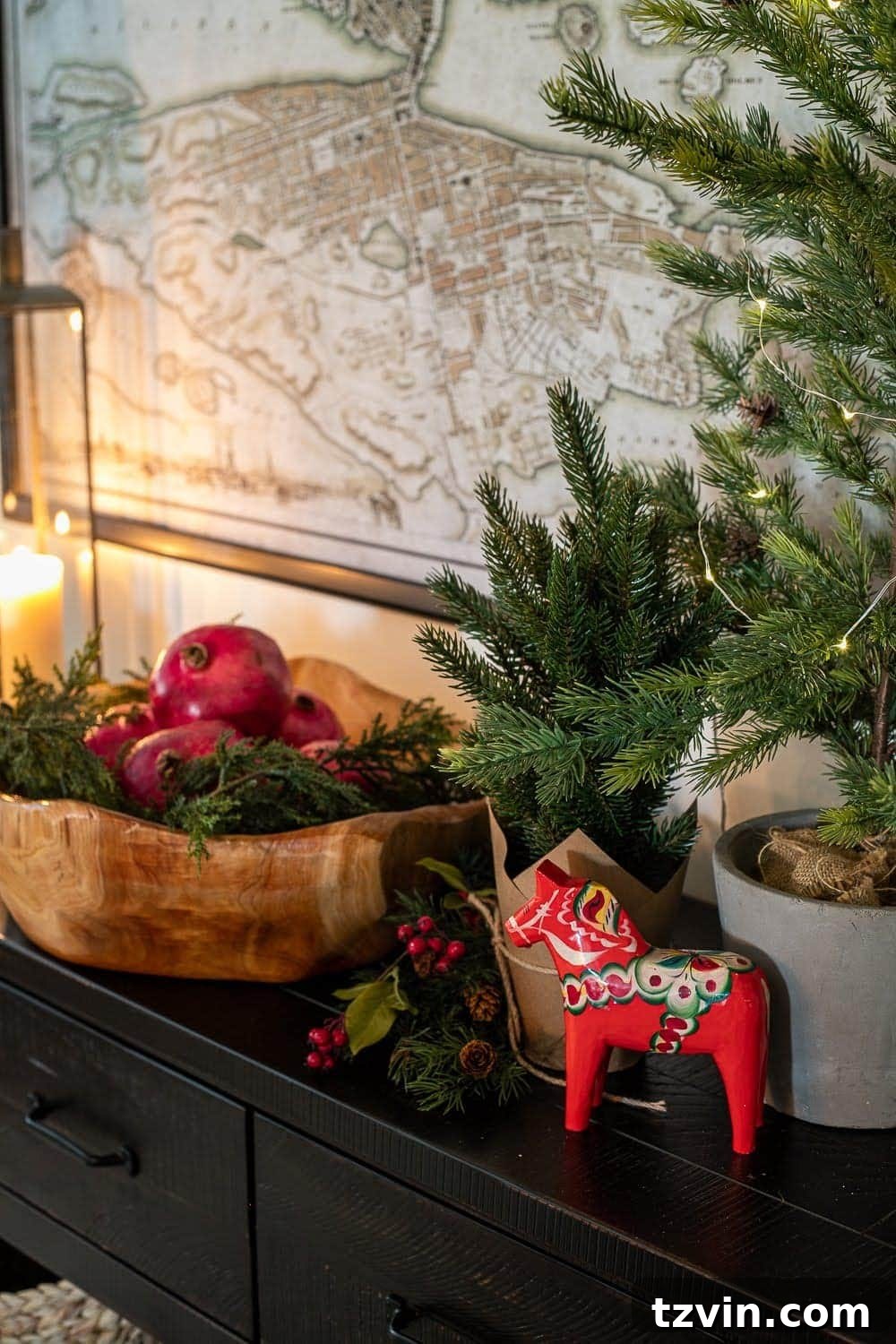 Swedish Christmas Charm: Blending Sentimental Decor with Modern Touches 12 A Swedish Christmas vignette with soft candlelight, a Dala horse, a bowl of pomegranates, and greenery, evoking a hygge atmosphere.