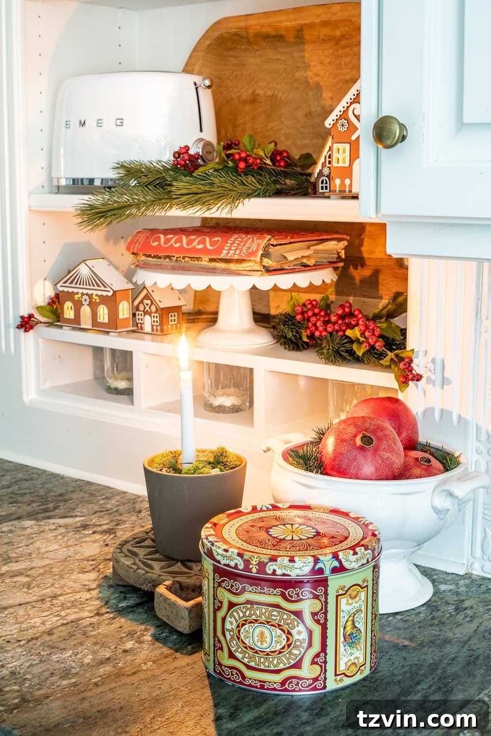Swedish Christmas Charm: Blending Sentimental Decor with Modern Touches 7 Swedish Christmas kitchen shelves adorned with old cookbooks, light-up wooden houses, and wooden cutting boards for a festive, rustic look.