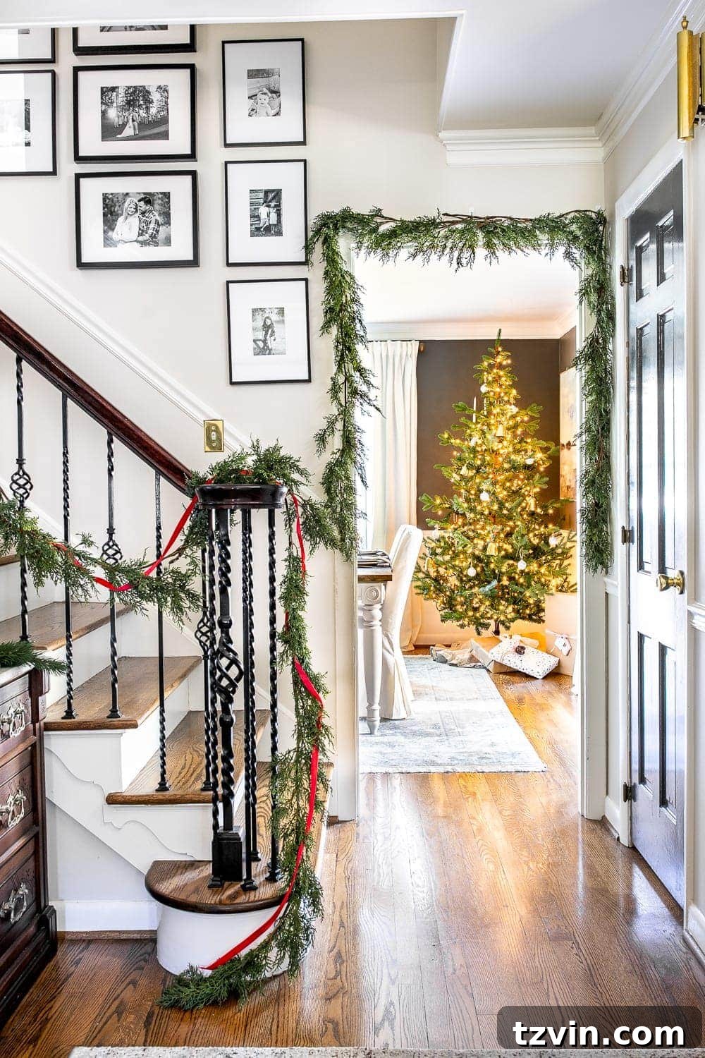 Traditional Christmas foyer with framed 'O Holy Night' sheet music and real looking faux garland