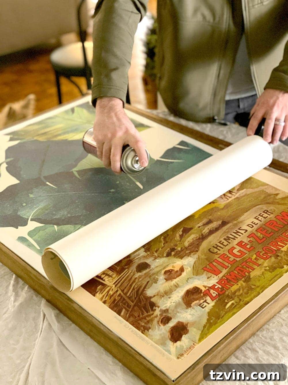 Creative Canvas Reimagined 6 Applying spray adhesive and pressing the poster onto the canvas edge