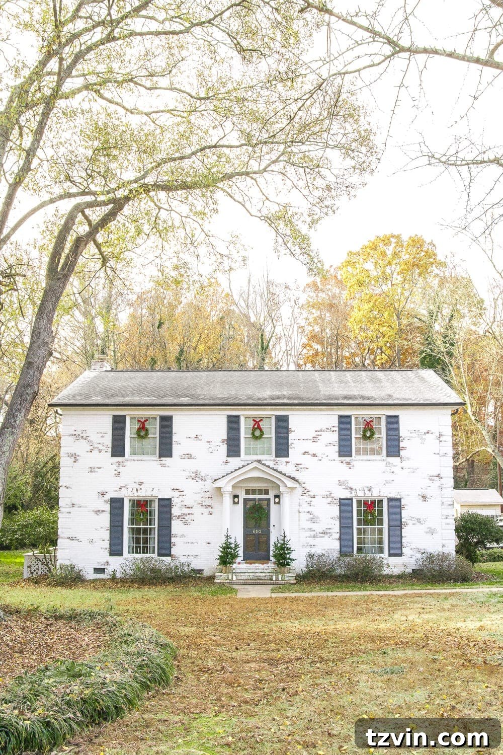 Front exterior of the house showing current landscaping before the planned overhaul.