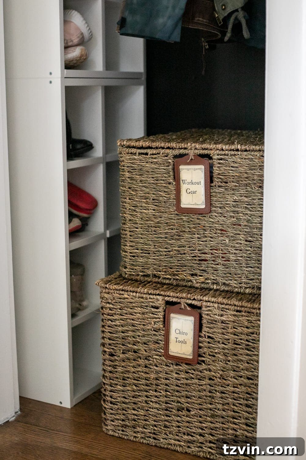 lidded baskets with labels in a coat closet for organizing workout gear