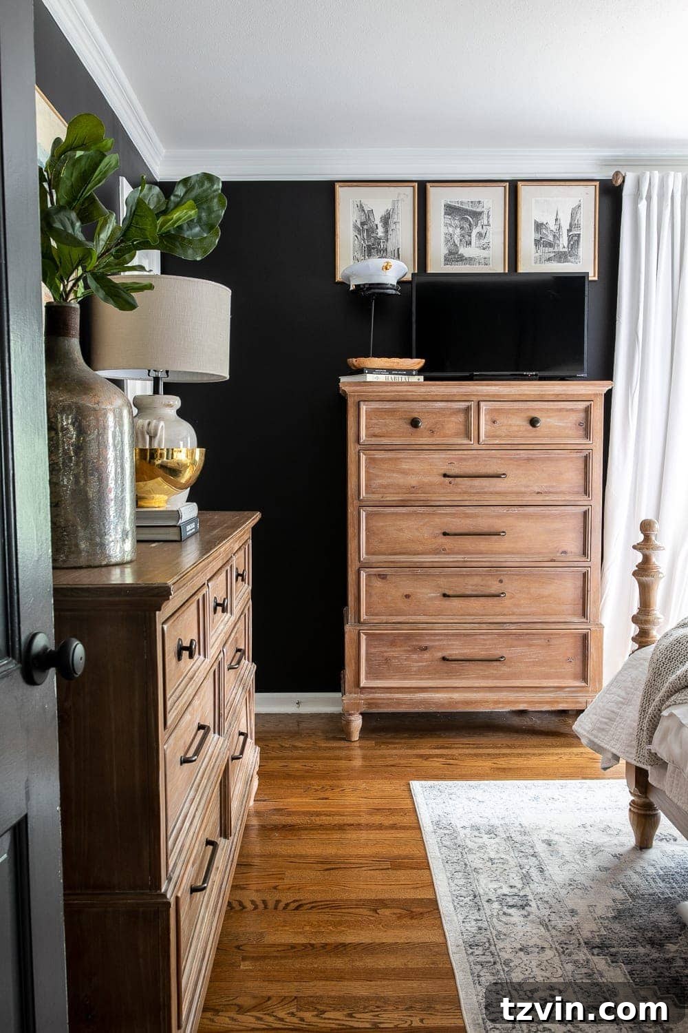 Moody Modern Vintage Master Bedroom Transformation 9 Moody modern vintage master bedroom with black paint and a TV discreetly placed on top of a dresser, surrounded by decor.