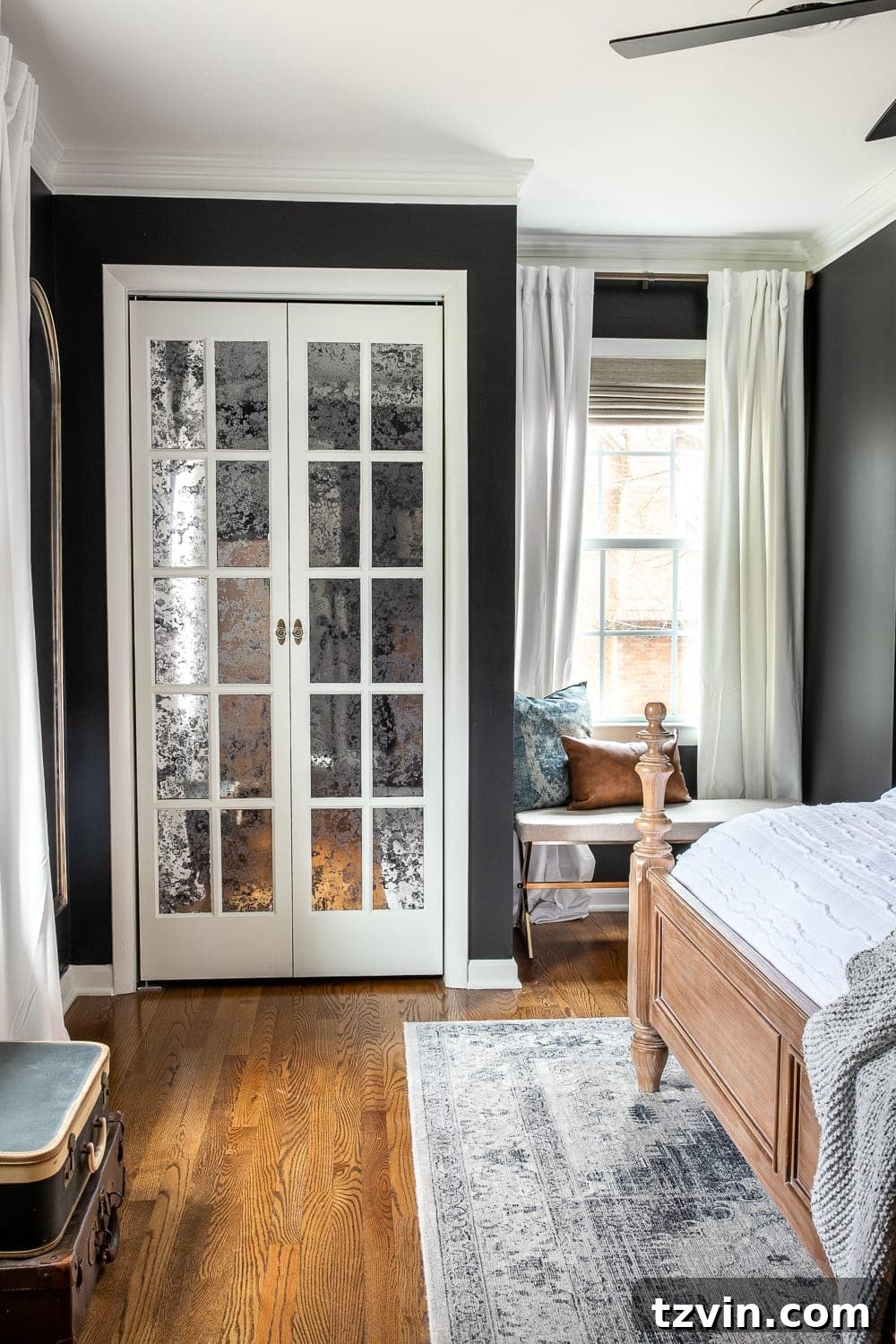 Moody Modern Vintage Master Bedroom Transformation 13 Black master bedroom with a large window dressed with white velvet curtains and woven Roman shades, adding contrast and texture.