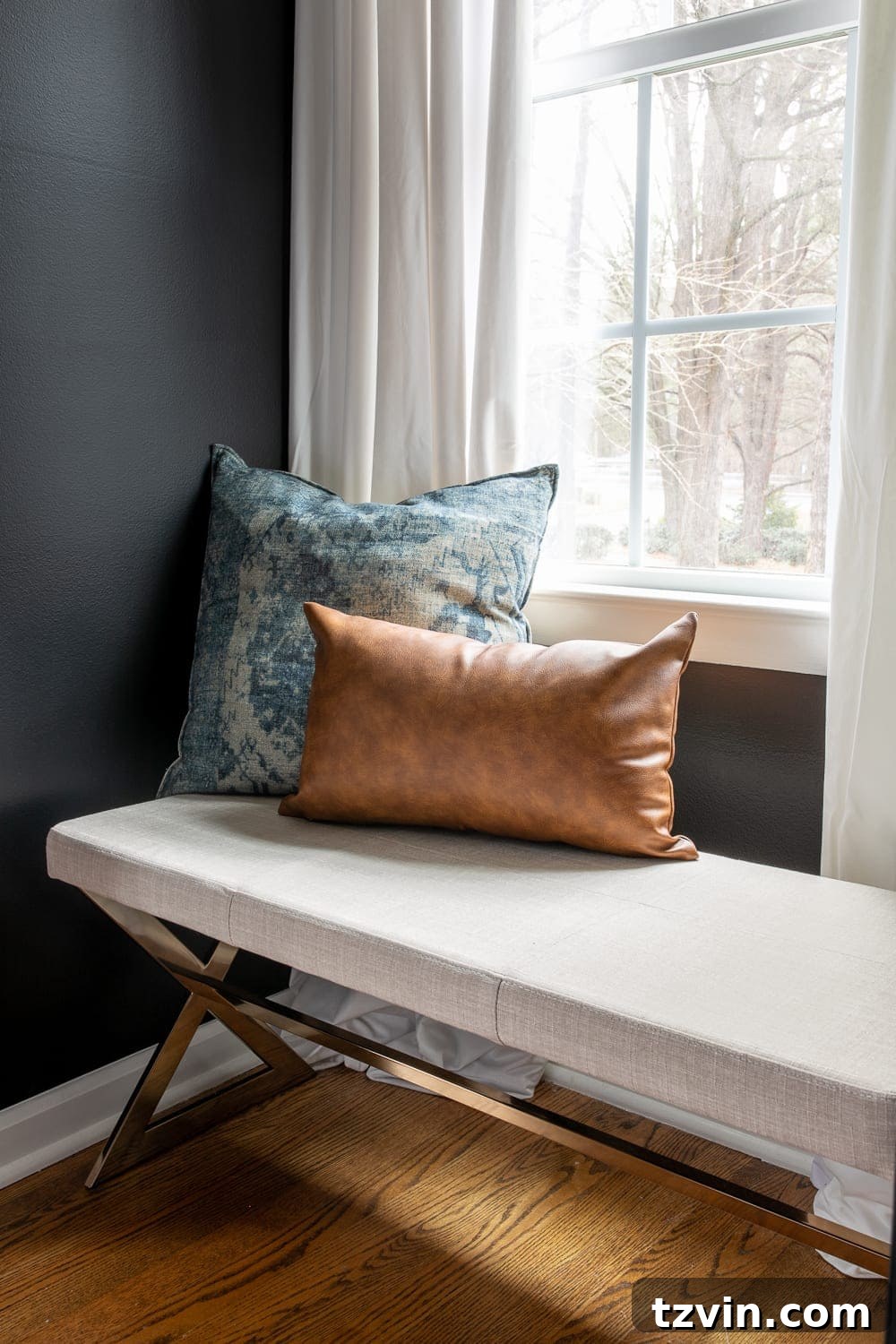 Moody Modern Vintage Master Bedroom Transformation 14 Master bedroom window seat featuring a stylish bench between two closets, offering practical and aesthetic value.