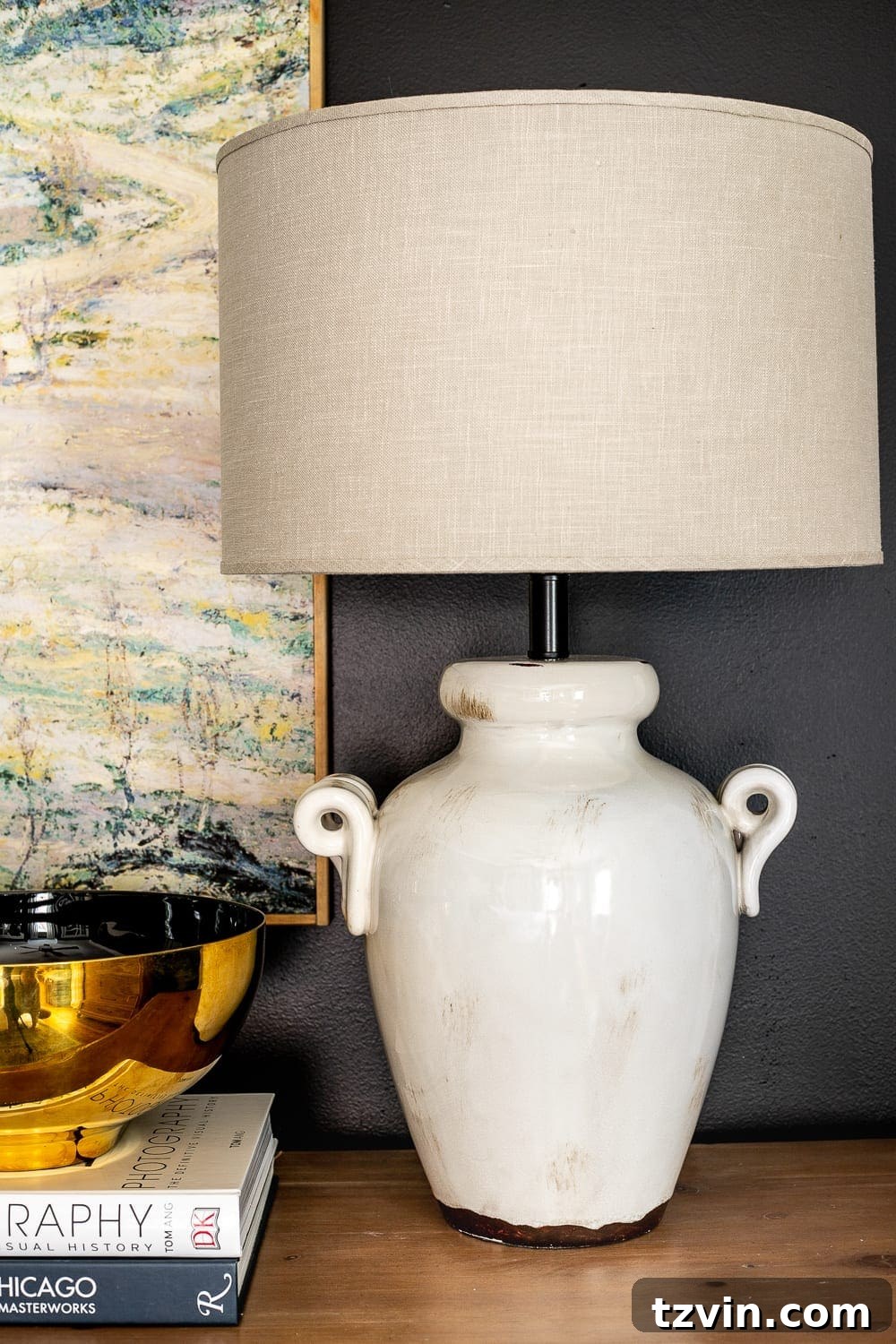 Moody Modern Vintage Master Bedroom Transformation 17 Master bedroom table lamp on a dresser, featuring a stylish base and shade, contributing to the moody ambiance.