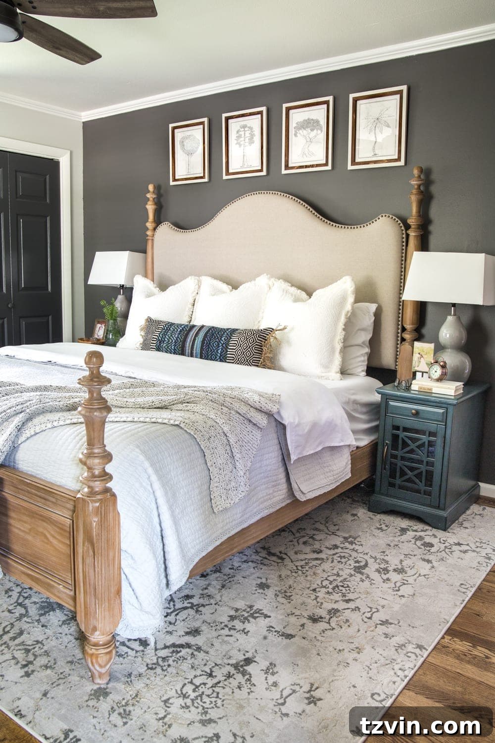 Moody Modern Vintage Master Bedroom Transformation 4 Modern vintage master bedroom with a dark accent wall behind the bed and light bedding.