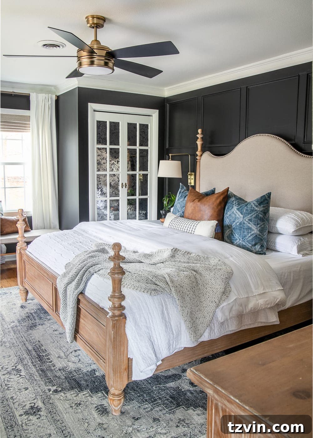Moody Modern Vintage Master Bedroom Transformation 5 A modern vintage master bedroom makeover with moody black paint covering all walls. The bed has light colored bedding and decorative pillows.