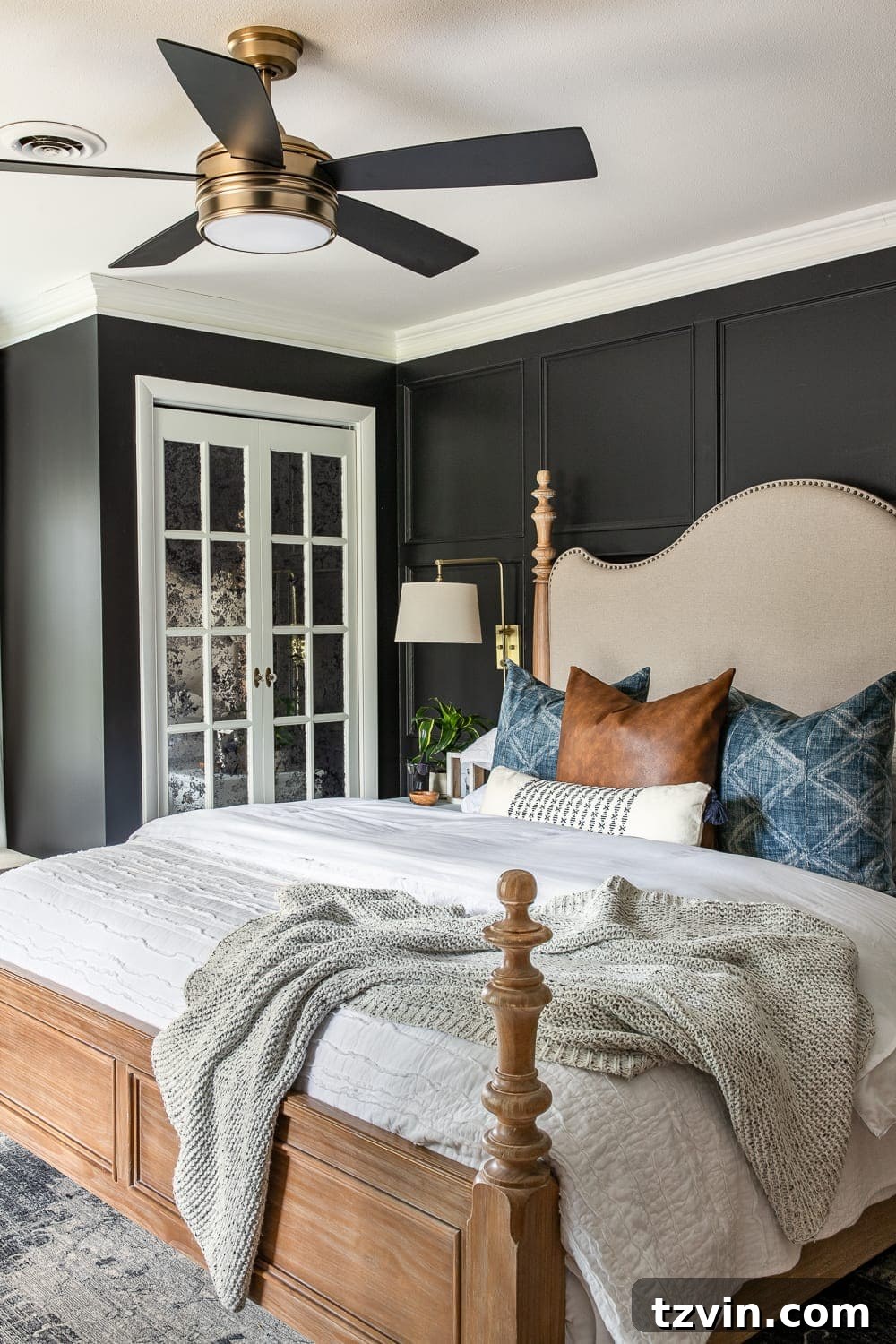 Moody Modern Vintage Master Bedroom Transformation 7 Moody modern vintage master bedroom with black paint, focusing on the bed with textured bedding and decorative pillows.
