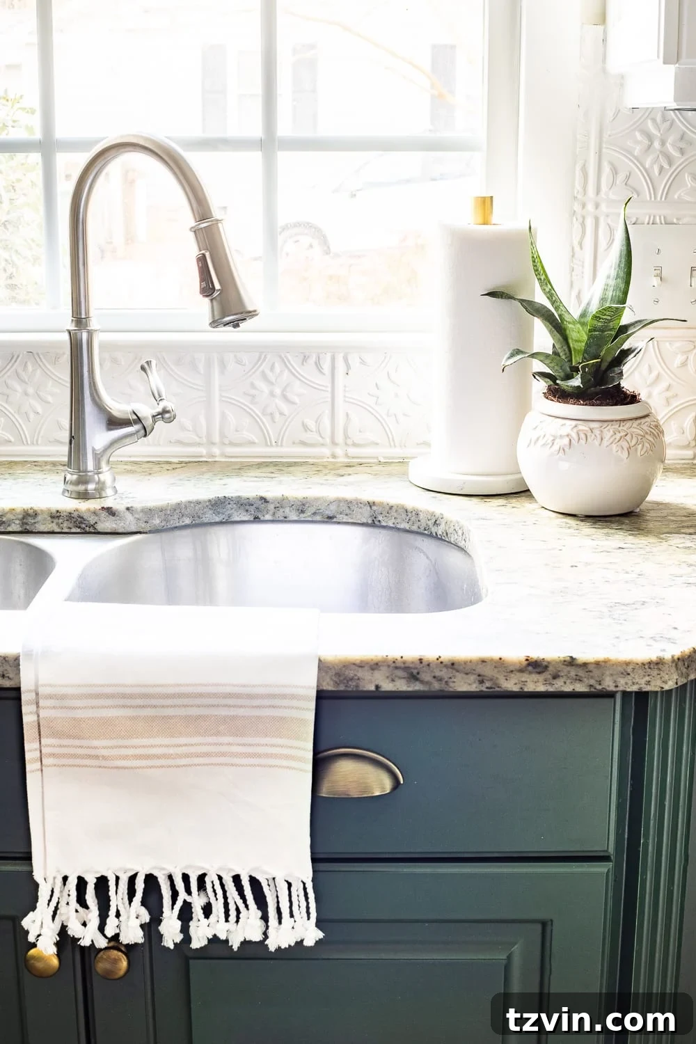 Stylish Countertops Made Simple 10 Decor elements beside a kitchen sink, including a live plant