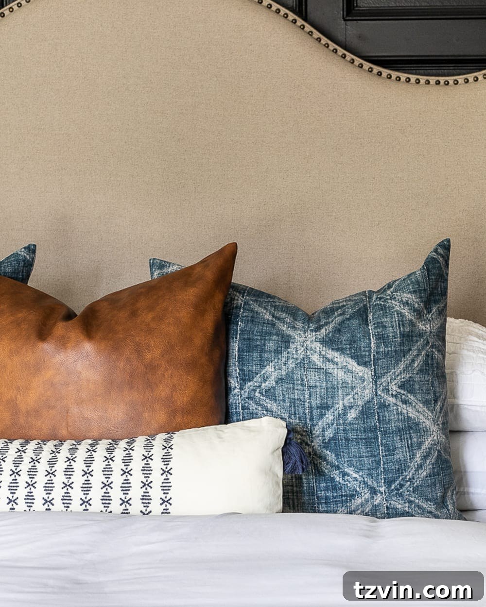 fluffy throw pillows on a bed