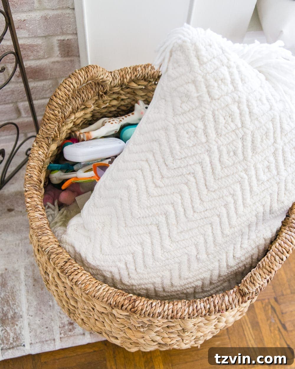 Taming Toy Chaos Our Sanity Solution 6 A stylish, woven toy basket filled with various children's toys, demonstrating practical and aesthetically pleasing living room toy storage.