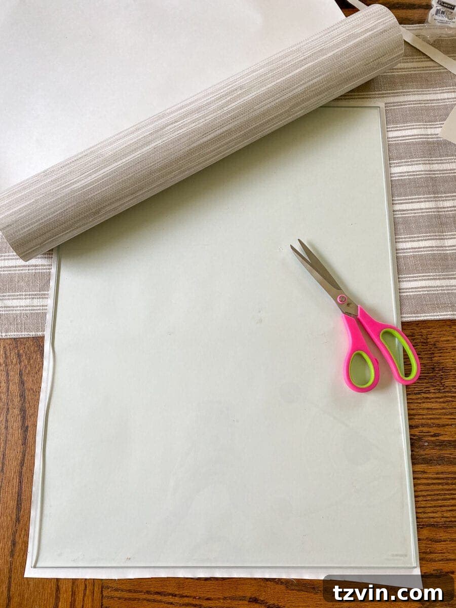 Chic Transformation of a Footed Grasscloth Buffet 7 Step 9: Applying removable grasscloth wallpaper to glass cabinet doors for texture and concealed storage