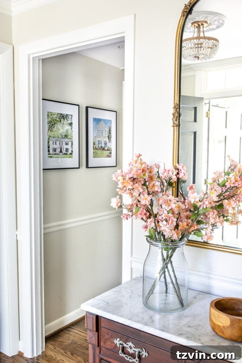 Your Home Transformed: Easy Photo to Painted Portrait Art 5 A series of framed house portraits displayed in a charming hallway gallery wall arrangement.