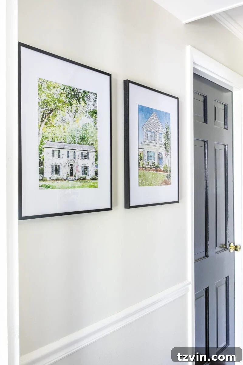 Your Home Transformed: Easy Photo to Painted Portrait Art 6 Close-up of a framed watercolor portrait of a white house with a welcoming porch and green landscaping.