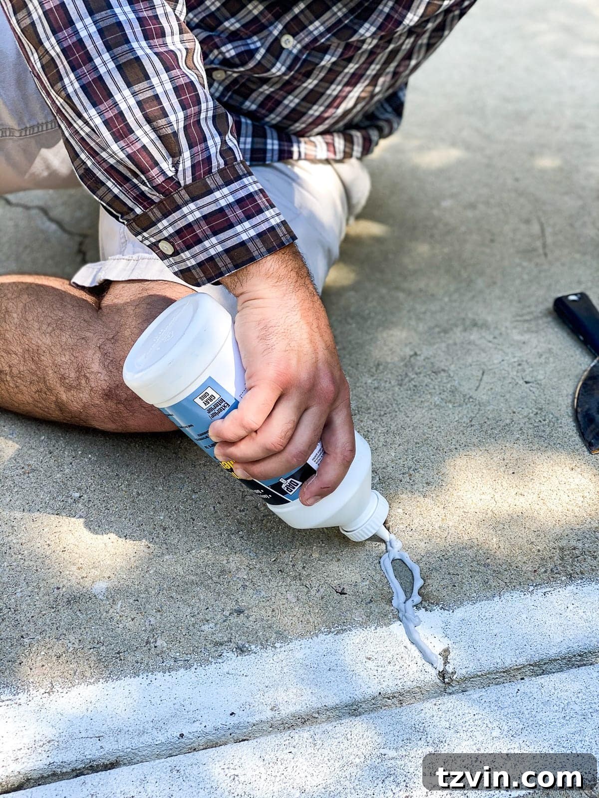 applying concrete filler to fill cracks and holes before painting