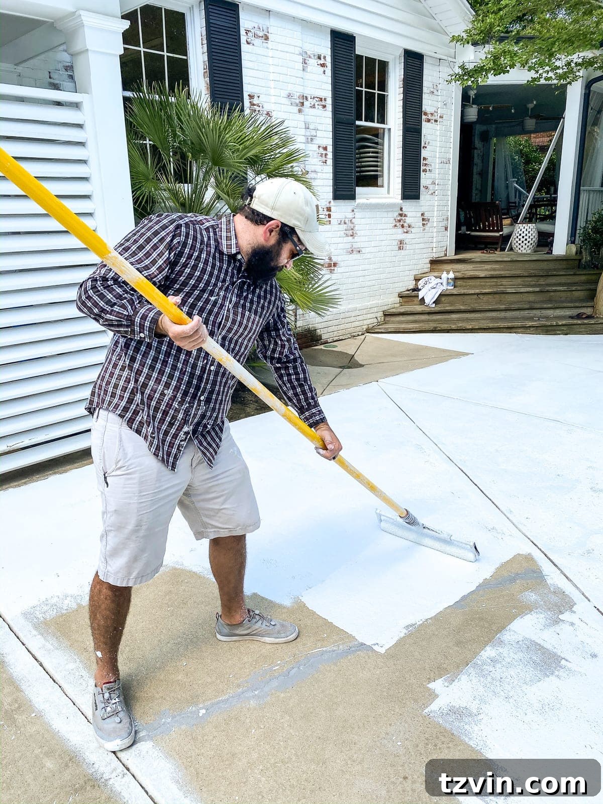 rolling on exterior primer before painting a concrete patio and pool deck