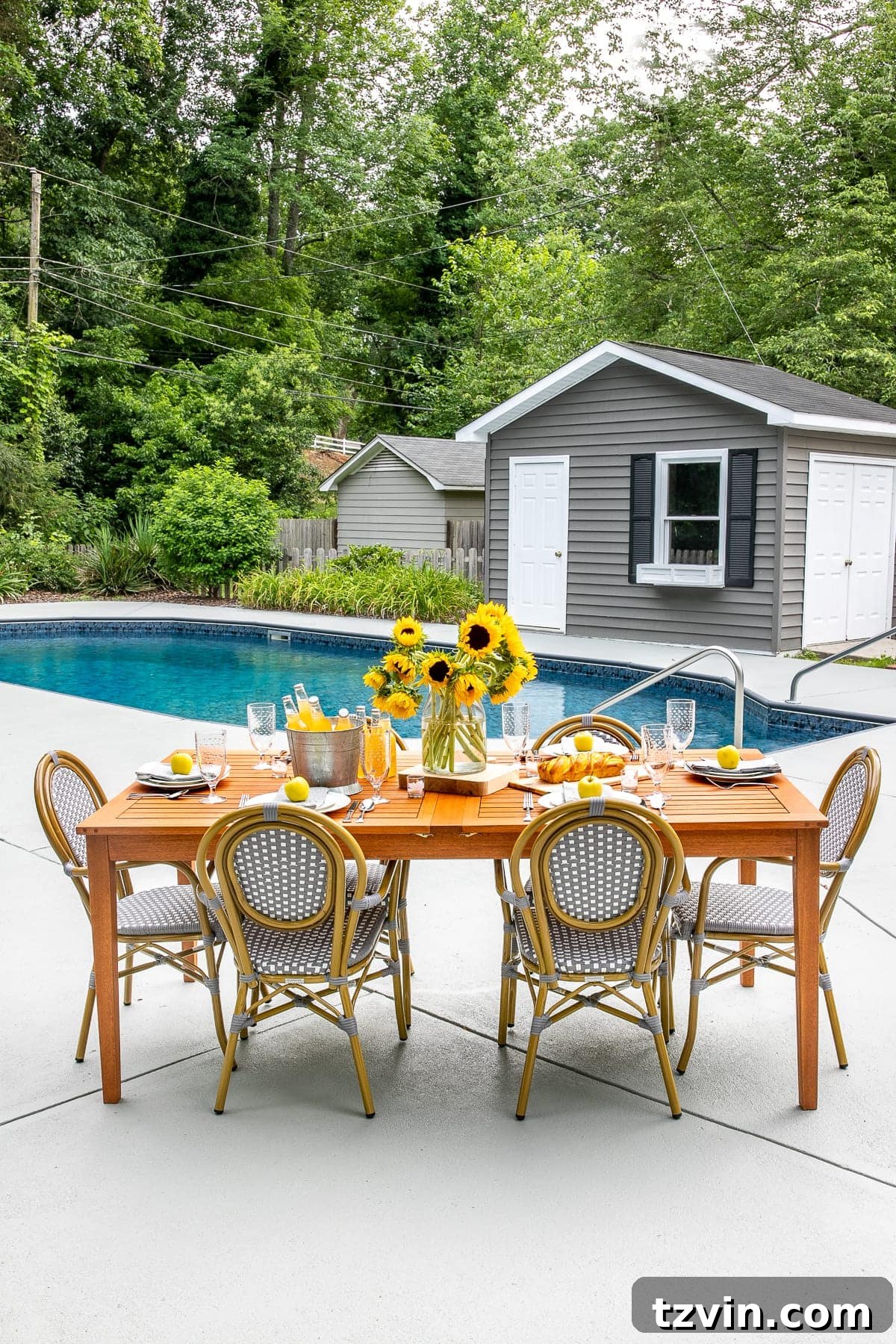 concrete pool deck with patio dining table and chairs