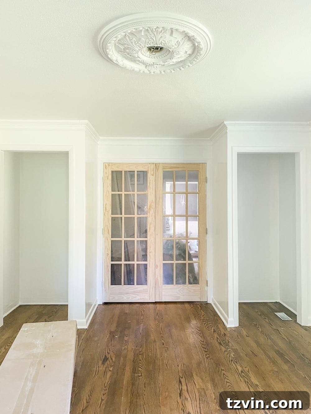 Simple Closet Transformation: Shelves and French Doors 2 Partially painted home office interior, showing walls and a glimpse of an unfinished closet space, hinting at the ongoing renovation.