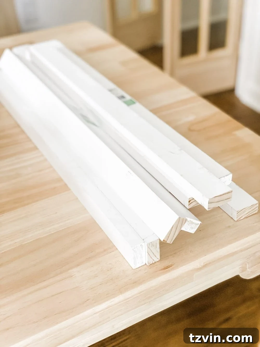 Simple Closet Transformation: Shelves and French Doors 10 A person cutting 1x2 wooden boards to length, likely for shelf support braces in a closet.