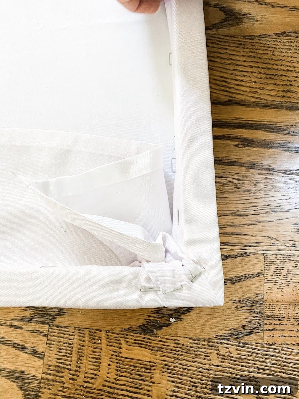 DIY Statement Piece: Oversized Wall Art from a Shower Curtain 11 Close-up of secured corner on DIY canvas