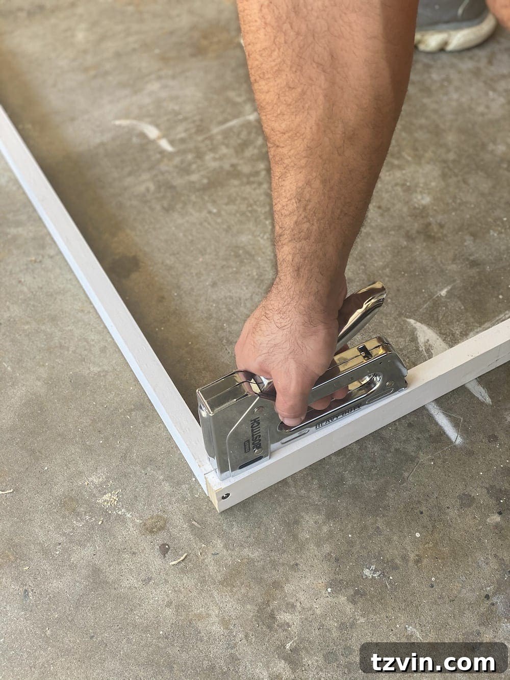 DIY Statement Piece: Oversized Wall Art from a Shower Curtain 7 Securing frame joints with staples