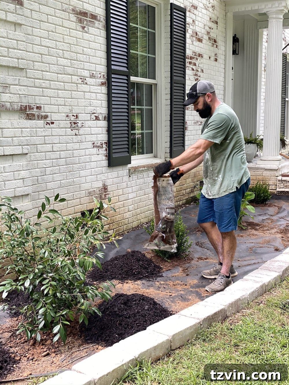 DIY Front Yard Flower Bed Glow Up 16 Applying brown rubber mulch to newly planted flower beds