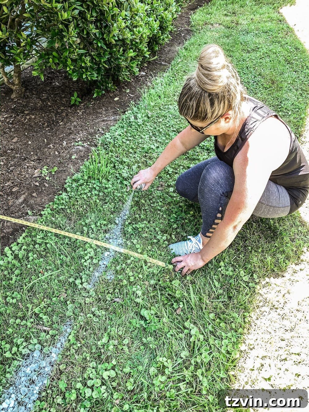 DIY Front Yard Flower Bed Glow Up 6 Measuring and marking new flower bed outlines with white spray paint