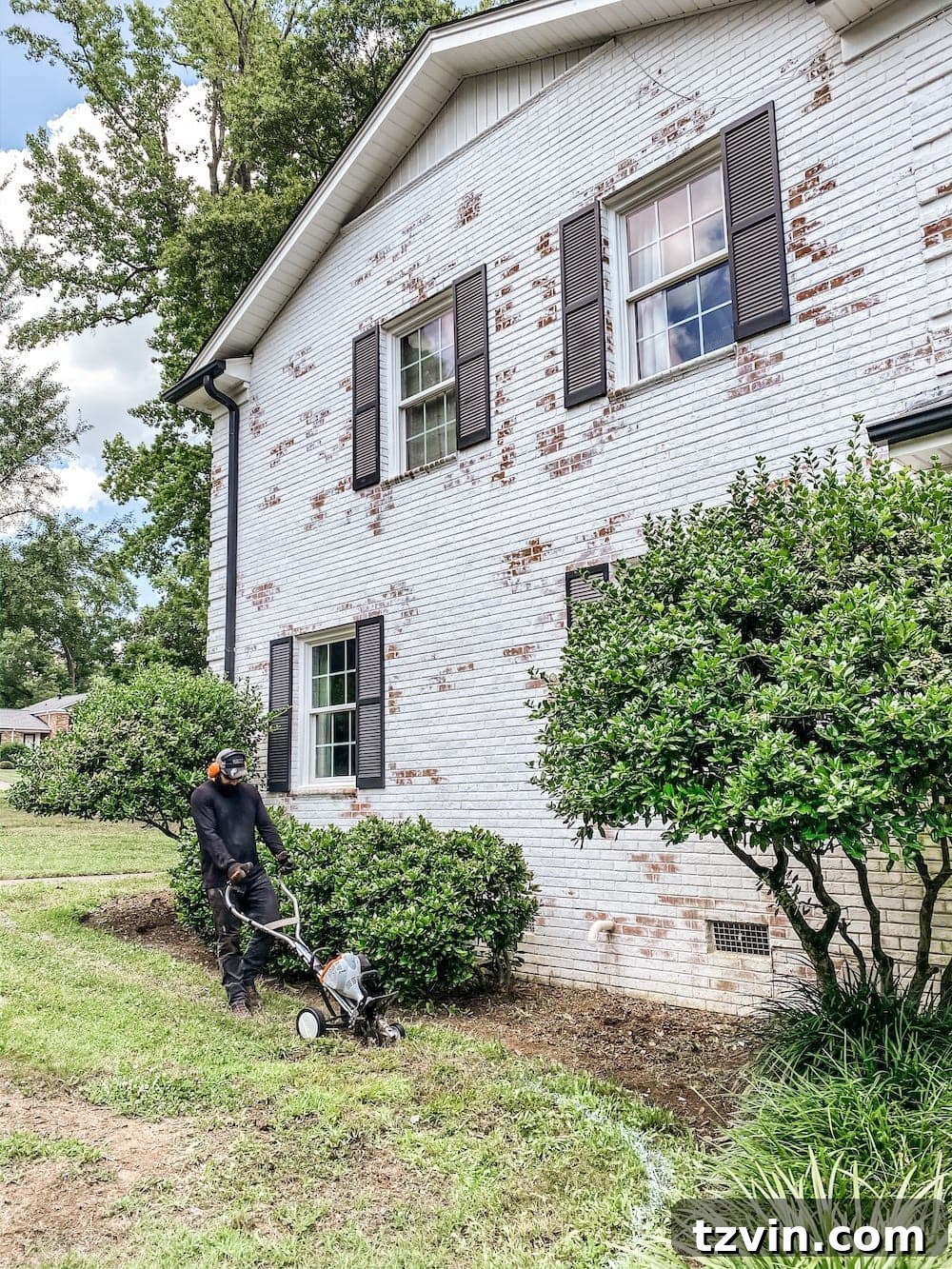 DIY Front Yard Flower Bed Glow Up 10 Gardener guiding the STIHL edger along a white spray paint line