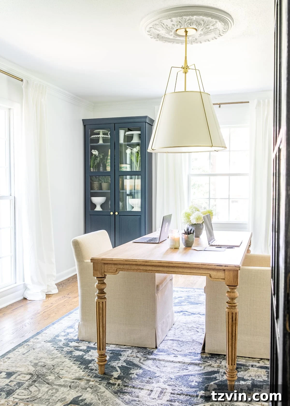 Our Home Office Transformation Unveiled 12 White and navy home office showcasing a work table, Hale Navy storage cabinets, and light walls in Benjamin Moore Chantilly Lace, offering a cohesive and stylish workspace.