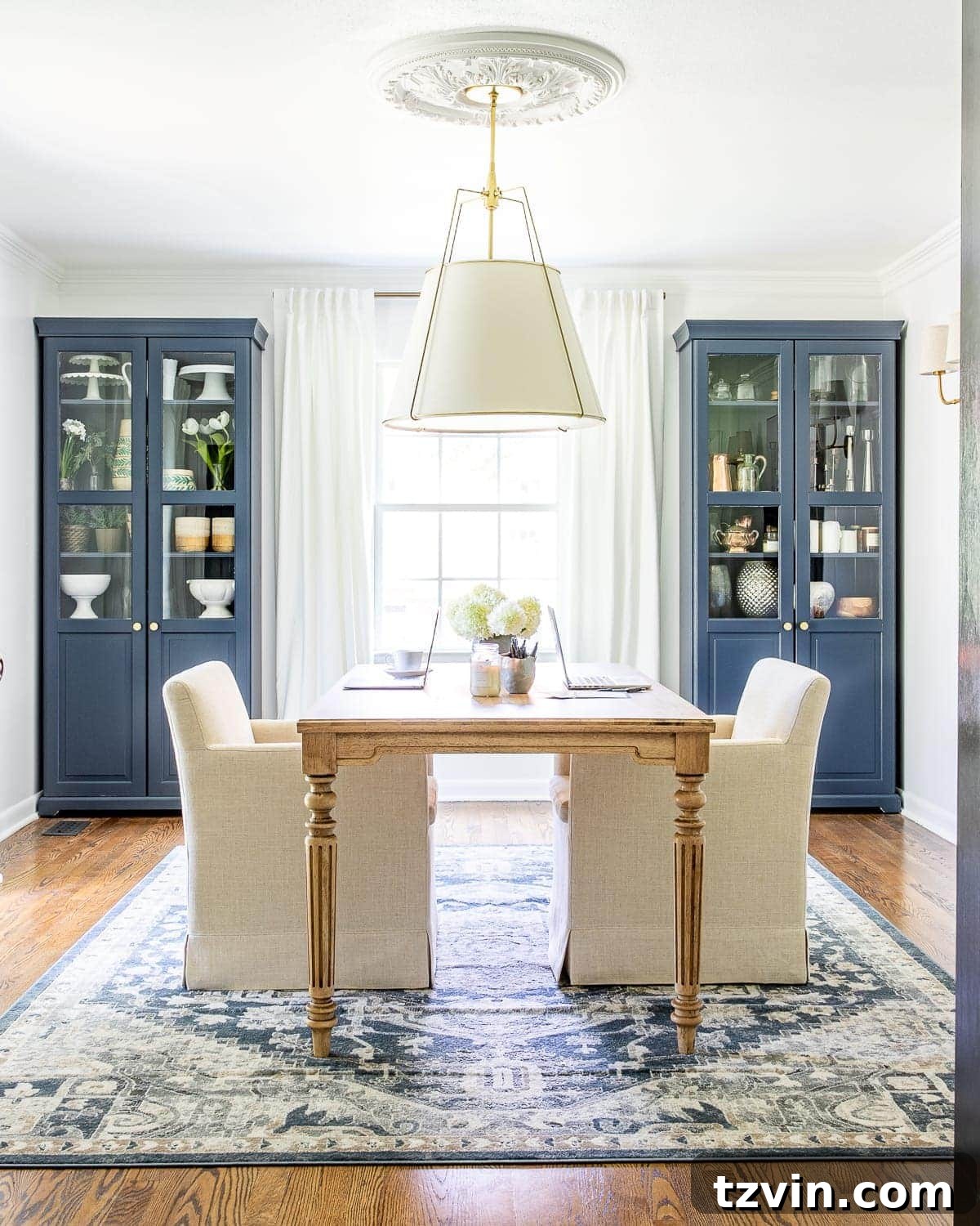 Our Home Office Transformation Unveiled 4 Bright and airy home office featuring a view towards a large work table, light-colored walls, and elegant furnishings, showcasing the complete room makeover.