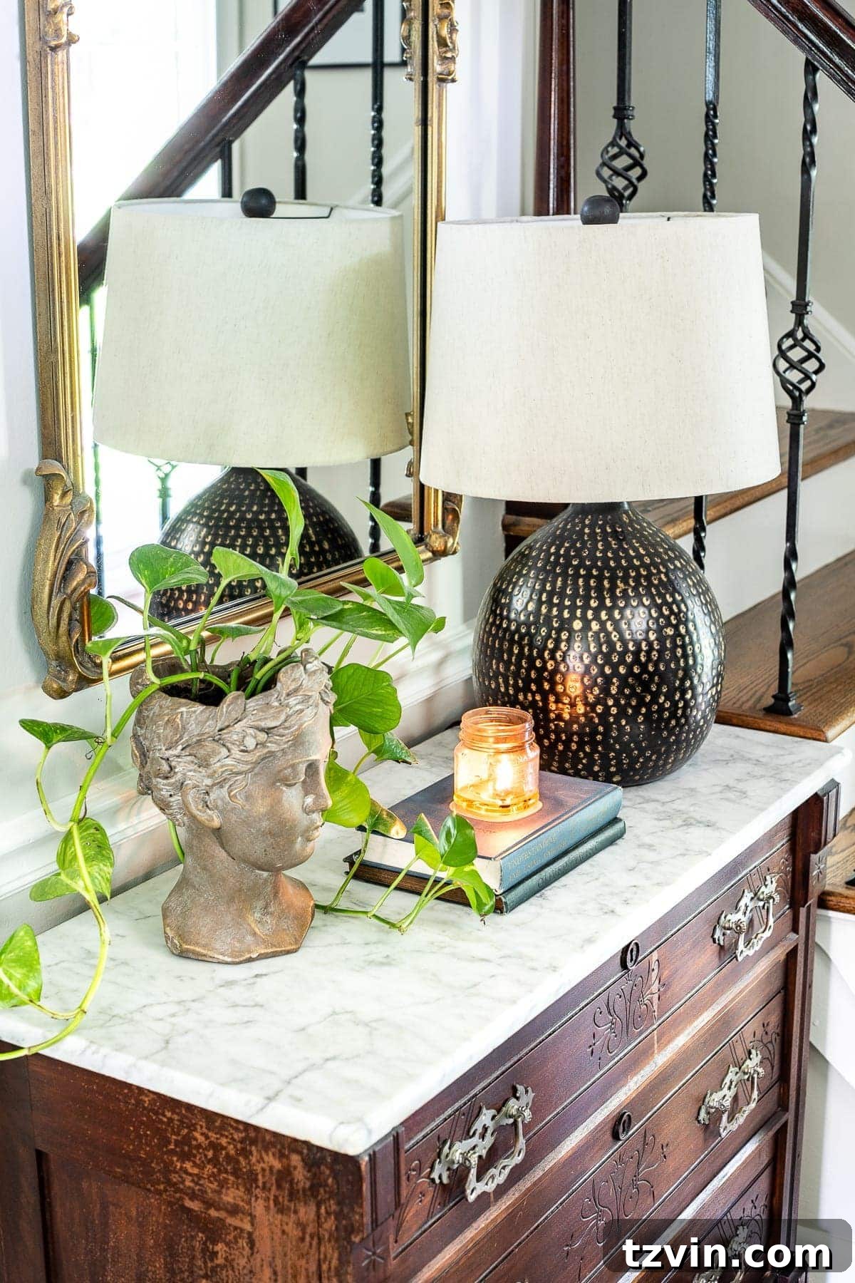 Foyer Fusion: Classic Charm Meets Modern Edge 8 Classic timeless modern foyer - bust planter, table lamp, chest styling vignette