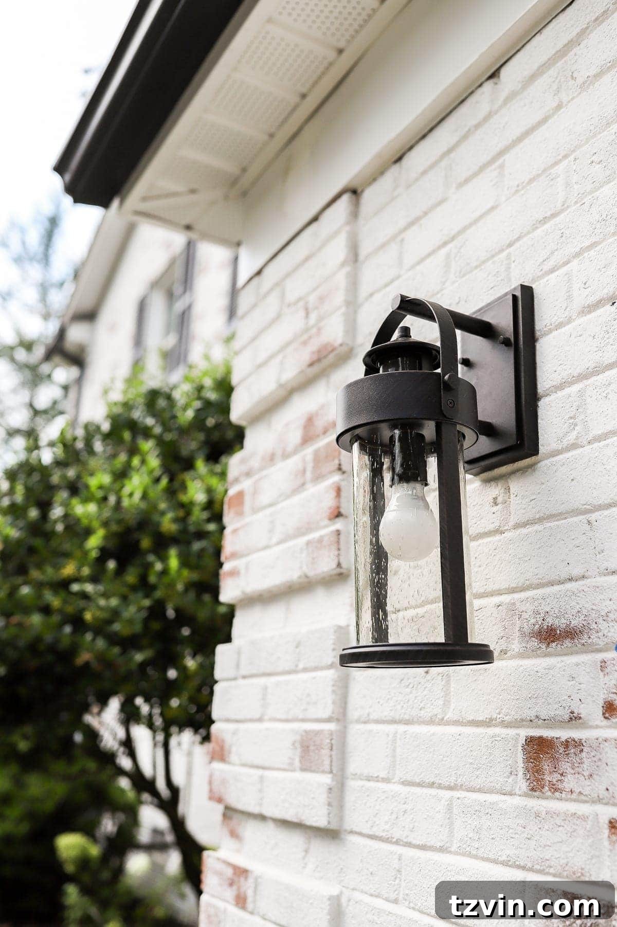 Stylish new motion sensor outdoor lantern installed on the house exterior.
